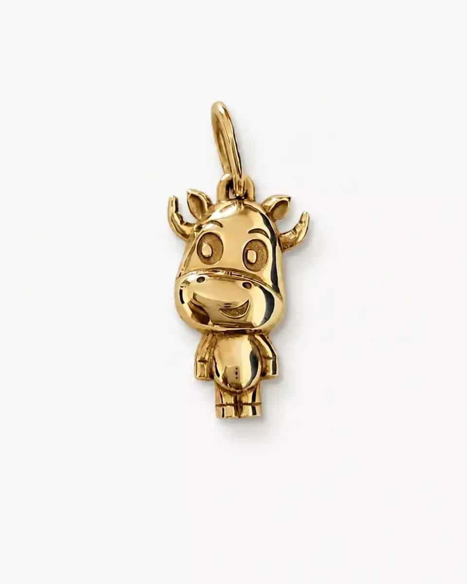 Gold sculptural cow pendant