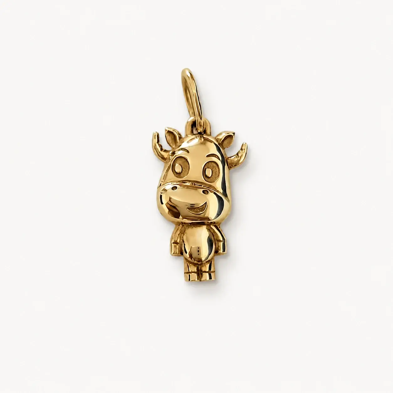 Gold sculptural cow pendant
