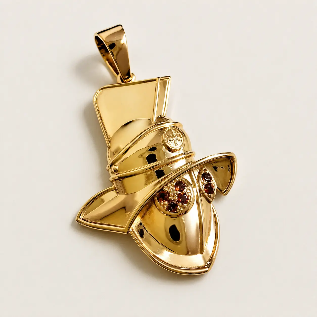 Gold sculptural mask pendant with stones